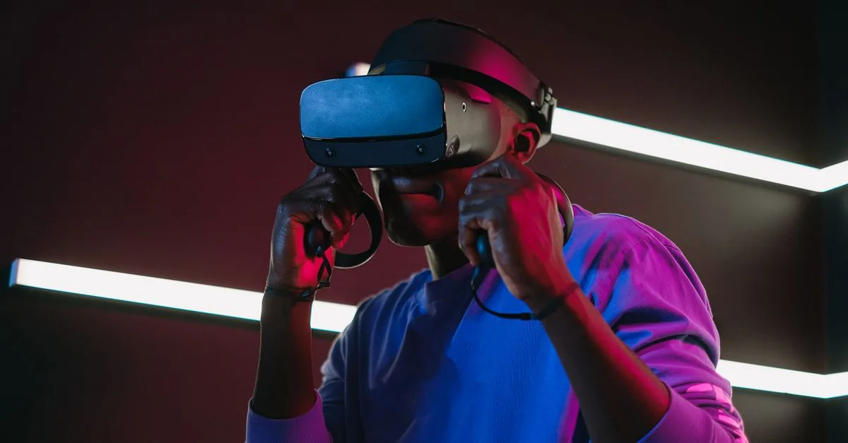 A man enjoys a virtual reality game with a VR headset in a colorful, modern game room.